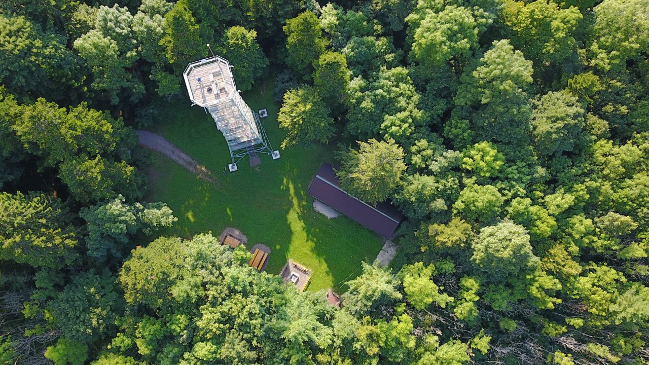 Aerial view of the Lembergturm surrounded by green trees with a view of the rest area and the refuge